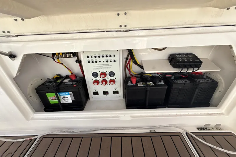 Slide: The Image of 2016 Robalo R300 Center Console battery compartment with wiring and control panel. - 24