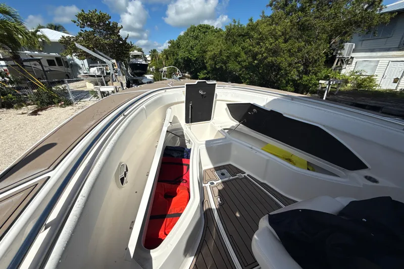 Slide: The Image of 2016 Robalo R300 Center Console boat interior with storage compartments open. - 27