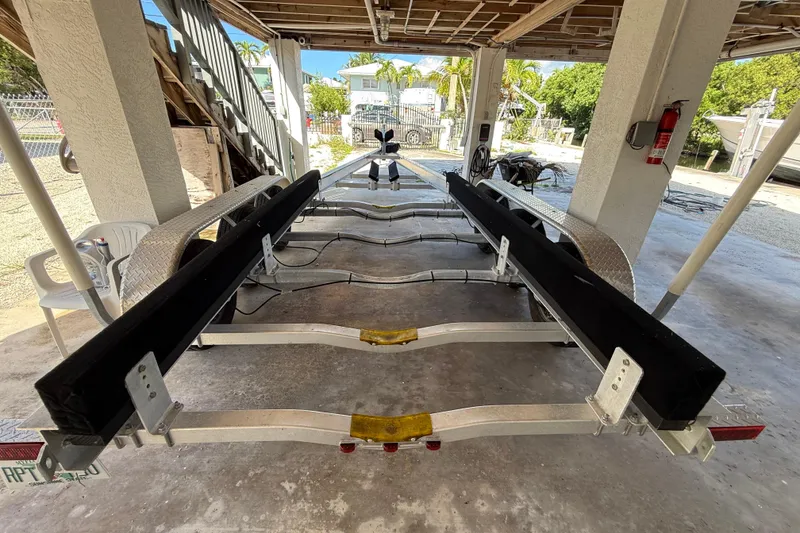 Slide: The Image of Boat trailer for 2016 Robalo R300 Center Console, parked under a covered area. - 38