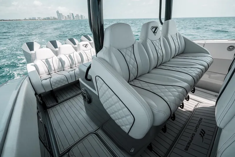 Slide: The Image of Luxurious seating on 2022 Midnight Express 43 Open boat, with ocean and city skyline backdrop. - 10