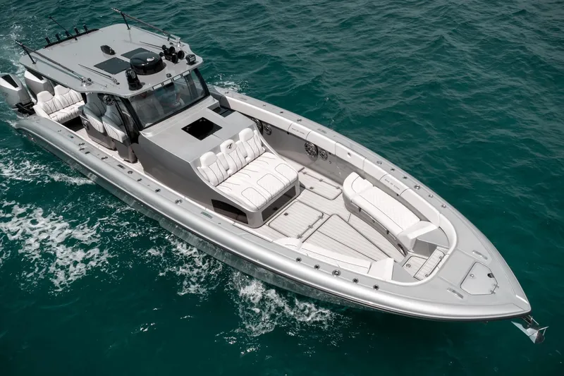 Slide: The Image of 2022 Midnight Express 43 Open luxury boat cruising on clear blue water. - 2