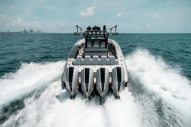 Slide: The Image of 2022 Midnight Express 43 Open boat cruising on ocean with city skyline in background. - 3