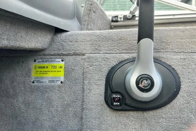 Slide: The Image of 2012 Smoker Craft Pro Angler XL 162 boat control panel with capacity label. - 11