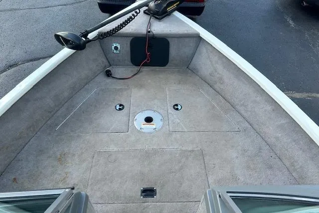 Slide: The Image of 2012 Smoker Craft Pro Angler XL 162 boat interior with carpeted deck and trolling motor. - 12
