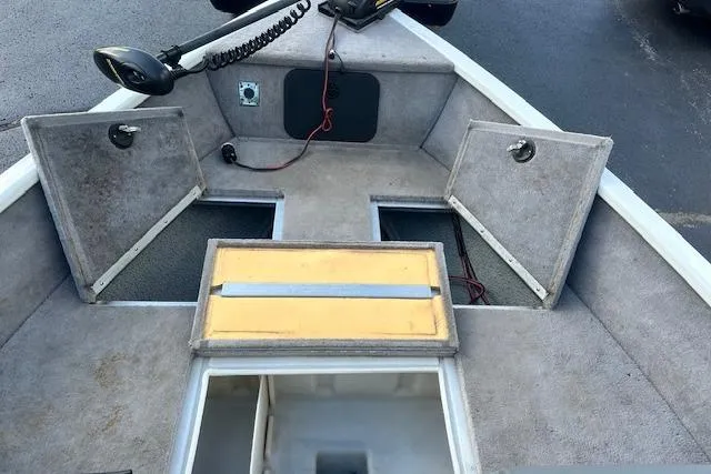 Slide: The Image of 2012 Smoker Craft Pro Angler XL 162 boat interior with storage compartments open. - 13