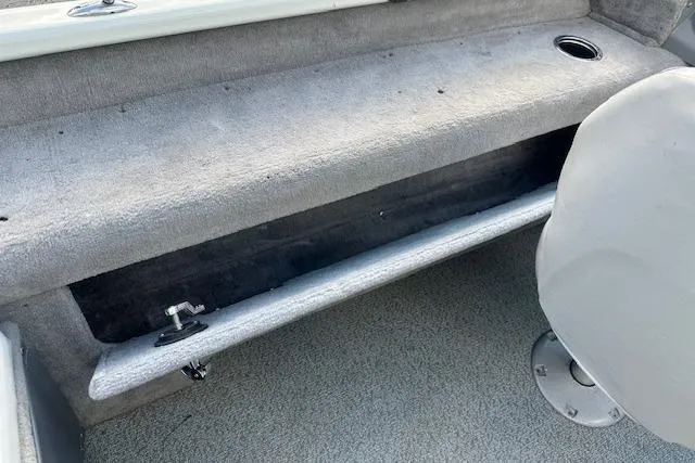 Slide: The Image of 2012 Smoker Craft Pro Angler XL 162 interior storage compartment with gray upholstery. - 18