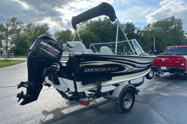 Slide: The Image of 2012 Smoker Craft Pro Angler XL 162 boat with Mercury engine on trailer. - 2