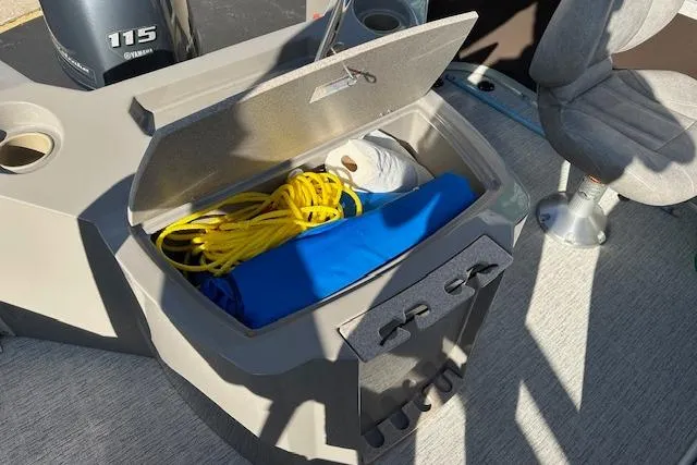 Slide: The Image of Open storage compartment on 2019 Premier 220 Gemini boat with rope and supplies. - 16