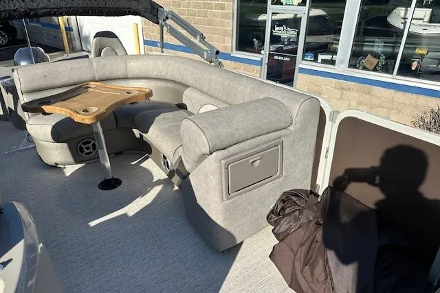 Slide: The Image of Premier 220 Gemini 2019 boat interior with gray seating and wooden table. - 21