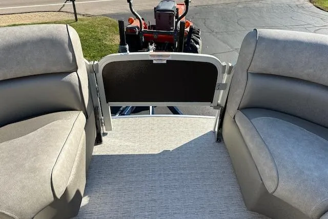Slide: The Image of 2019 Premier 220 Gemini boat interior with gray seating and a view of a tractor outside. - 22