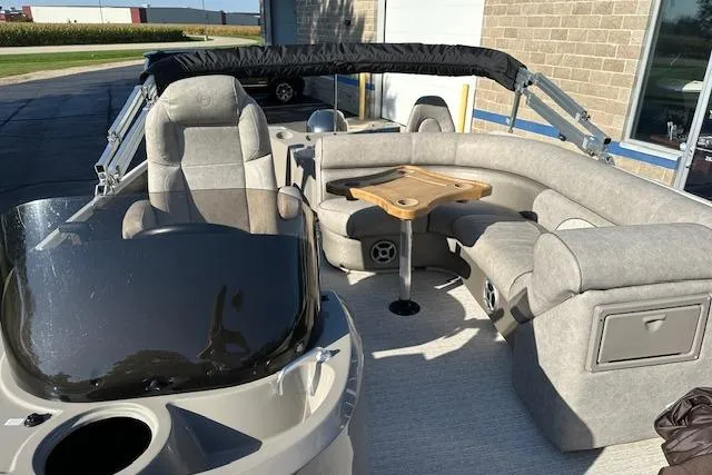 Slide: The Image of 2019 Premier 220 Gemini boat interior with plush seating and a wooden table. - 23