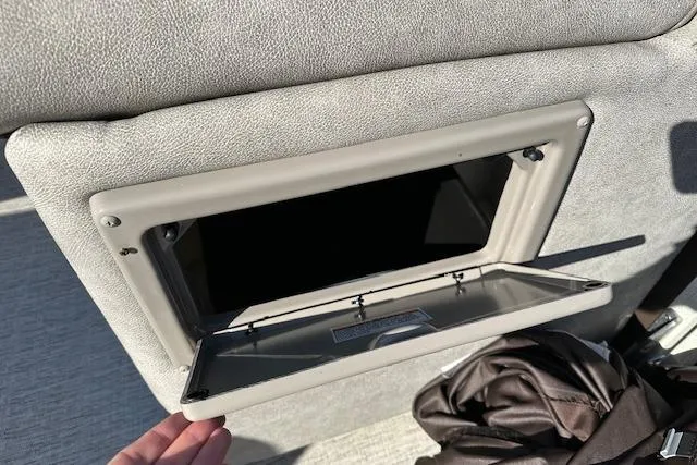 Slide: The Image of Open storage compartment in 2019 Premier 220 Gemini boat interior. - 24