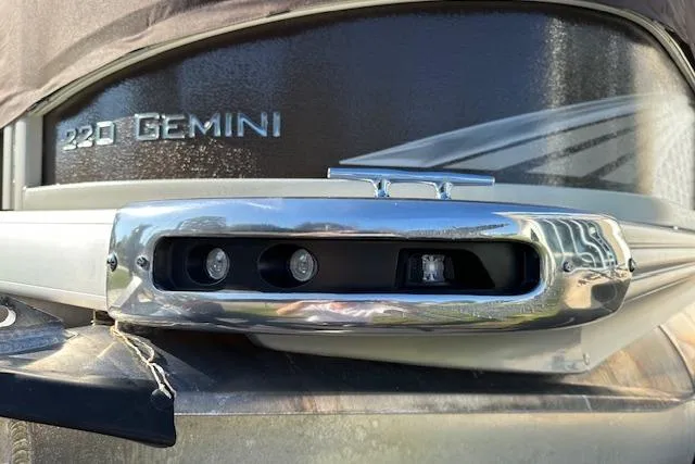 Slide: The Image of 2019 Premier 220 Gemini boat with chrome detailing and sleek design. - 7
