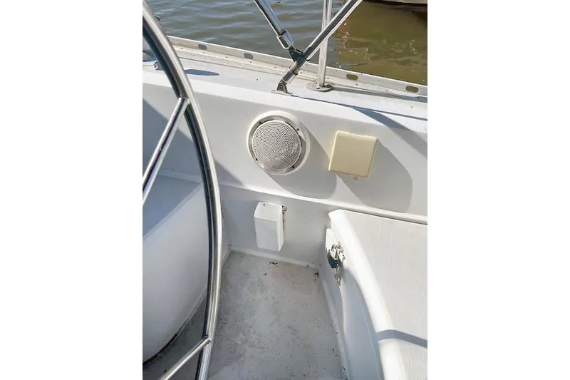 Slide: The Image of 1988 O'Day 322 sailboat cockpit with steering wheel and speaker detail. - 10