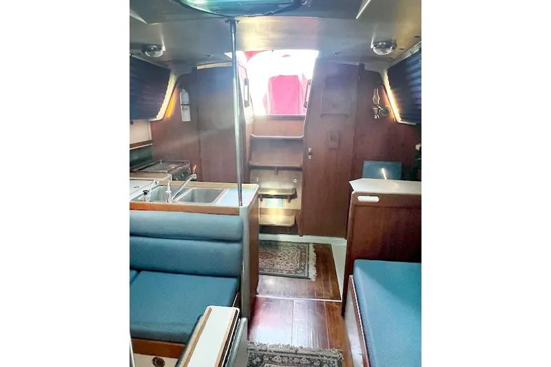 Slide: The Image of Interior of 1988 O'Day 322 sailboat with wood finish and blue seating. - 12