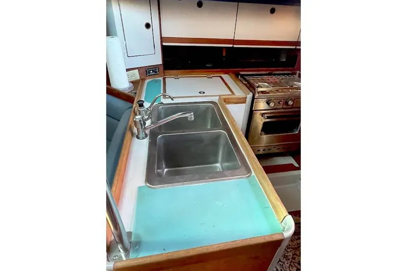 Slide: The Image of 1988 O'Day 322 yacht kitchen with double sink and stove. - 13