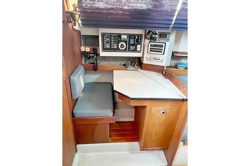 Slide: The Image of 1988 O'Day 322 sailboat interior with navigation station and control panel. - 14