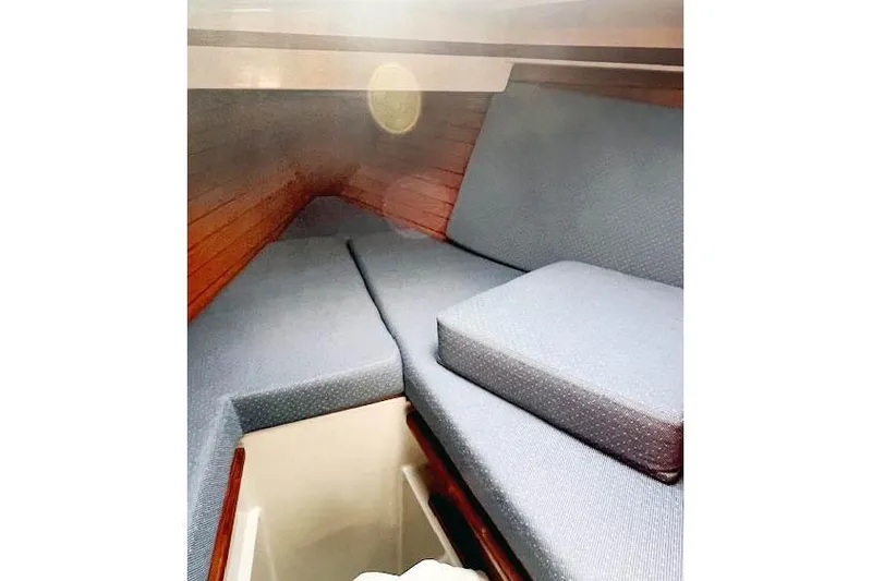 Slide: The Image of Interior cabin of 1988 O'Day 322 sailboat with blue cushions and wooden paneling. - 15
