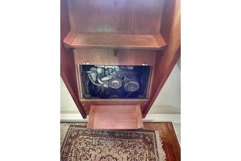 Slide: The Image of 1988 O'Day 322 engine compartment with wooden paneling and carpeted floor. - 19