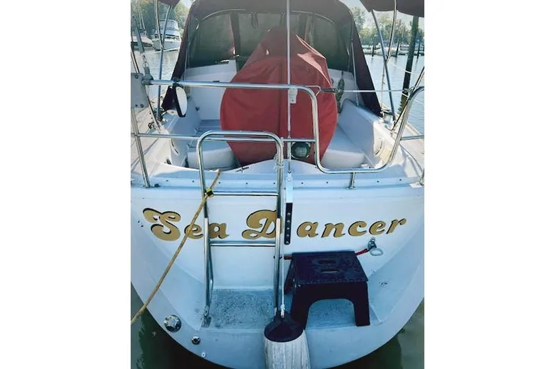 Slide: The Image of 1988 O'Day 322 sailboat "Sea Dancer" docked, featuring a covered cockpit area. - 2