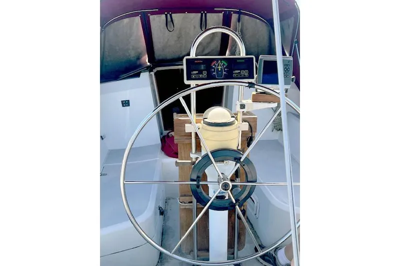 Slide: The Image of 1988 O'Day 322 sailboat cockpit with steering wheel and navigation instruments. - 8