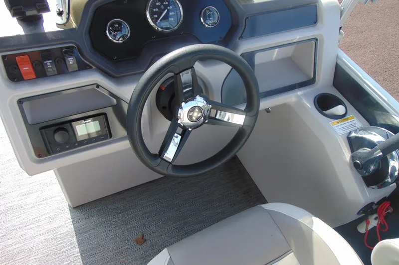 Slide: The Image of Steering console of 2022 Godfrey Sweetwater 1680 CX boat with gauges and controls. - 12