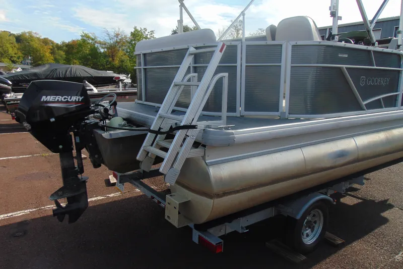Slide: The Image of 2022 Godfrey Sweetwater 1680 CX pontoon boat with Mercury outboard motor on trailer. - 4