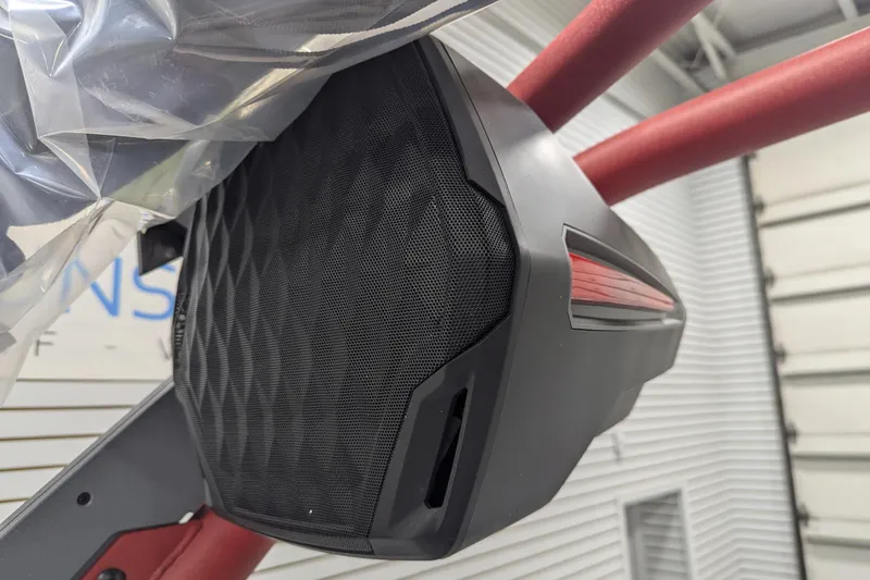 Slide: The Image of 2026 Malibu Wakesetter 23 LSV speaker detail with red accents in a garage setting. - 11