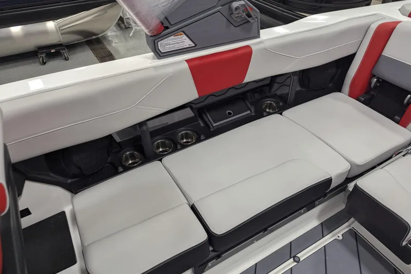 Slide: The Image of 2026 Malibu Wakesetter 23 LSV interior seating with cup holders and red accents. - 14