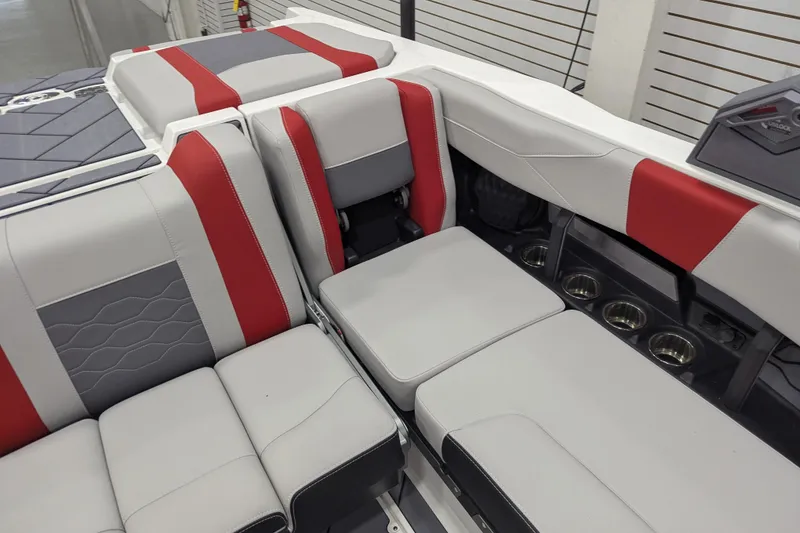 Slide: The Image of 2026 Malibu Wakesetter 23 LSV interior with red and gray seating, cup holders visible. - 16