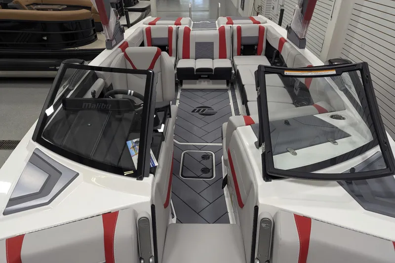 Slide: The Image of 2026 Malibu Wakesetter 23 LSV interior with red and gray seating, sleek design. - 19