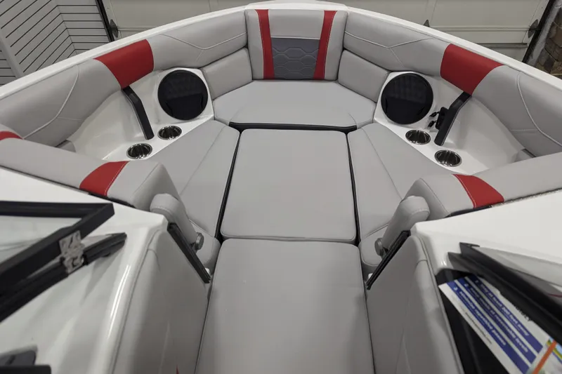 Slide: The Image of 2026 Malibu Wakesetter 23 LSV interior with gray and red seating, cup holders, and speakers. - 23