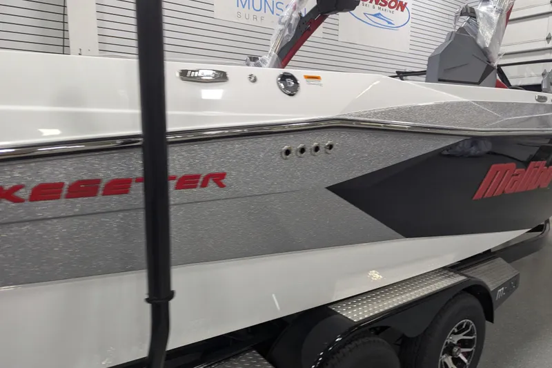 Slide: The Image of 2026 Malibu Wakesetter 23 LSV boat in showroom, featuring sleek design and branding. - 3