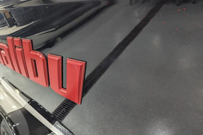 Slide: The Image of Close-up of 2026 Malibu Wakesetter 23 LSV logo on a sleek black surface. - 7