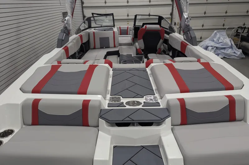 Slide: The Image of 2026 Malibu Wakesetter 23 LSV interior with red and gray seating in a garage setting. - 8