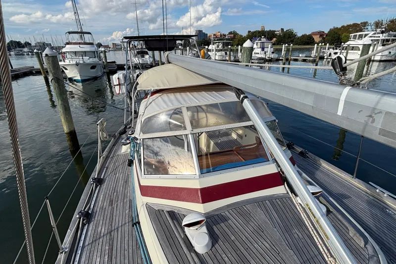 Slide: The Image of 1992 Najad 390 sailboat docked at marina, featuring wooden deck and covered cockpit. - 12