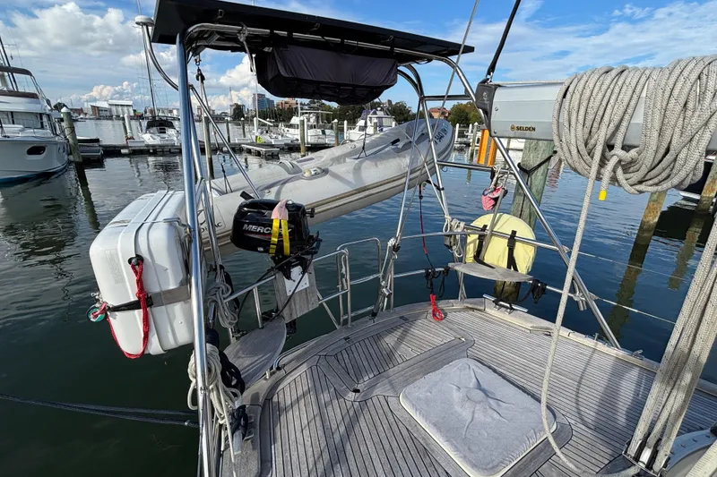 Slide: The Image of Najad 390 sailboat deck, 1992 model, with dinghy and marina view. - 13