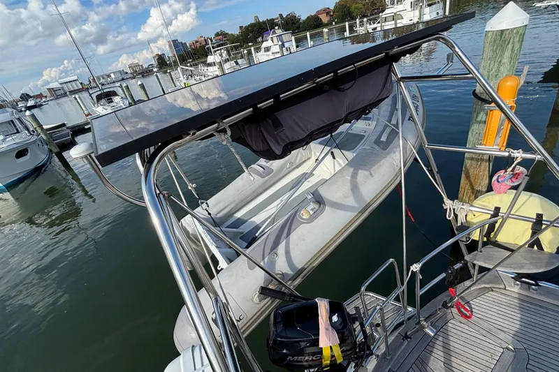Slide: The Image of Najad 390 sailboat from 1992 with dinghy and solar panel at marina. - 14