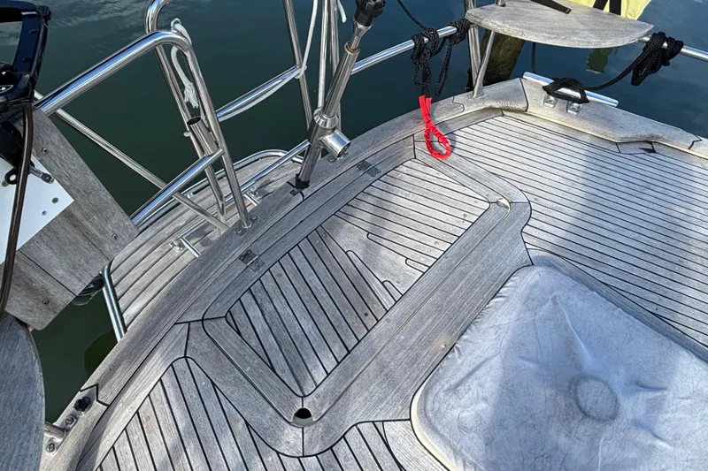 Slide: The Image of Teak deck of 1992 Najad 390 sailboat with stainless steel railings and red rope. - 24