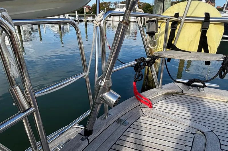 Slide: The Image of Sailboat deck of 1992 Najad 390 with polished railings and dock view. - 27