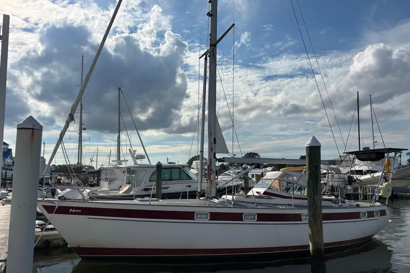 Slide: The Image of 1992 Najad 390 sailboat docked at marina under cloudy sky. - 3