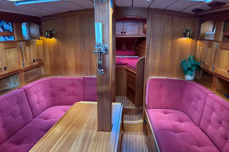 Slide: The Image of Luxurious 1992 Najad 390 yacht interior with plush red seating and wooden cabinetry. - 31