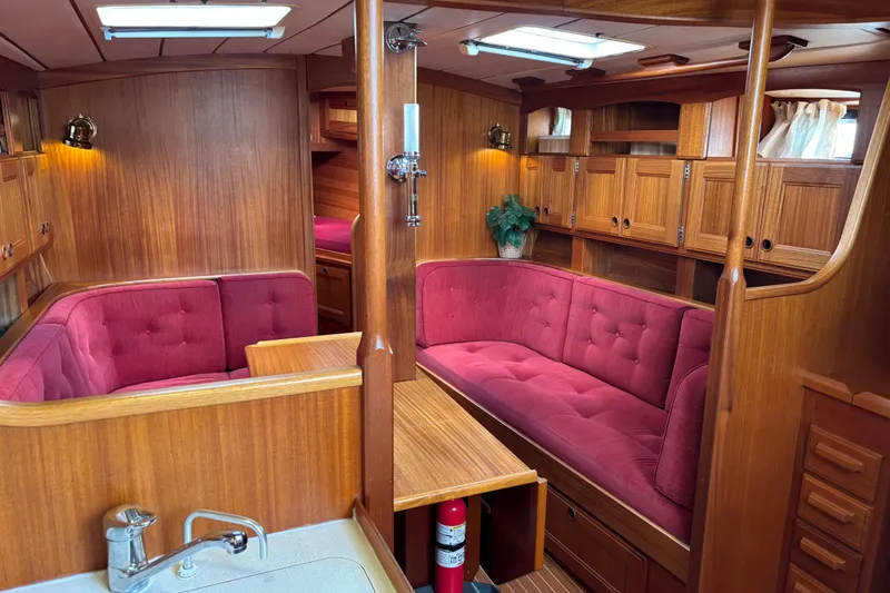 Slide: The Image of Interior of 1992 Najad 390 yacht with wood paneling and red cushioned seating. - 32