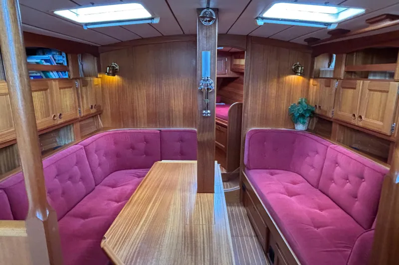 Slide: The Image of Interior of 1992 Najad 390 yacht with wood paneling and red cushioned seating. - 33