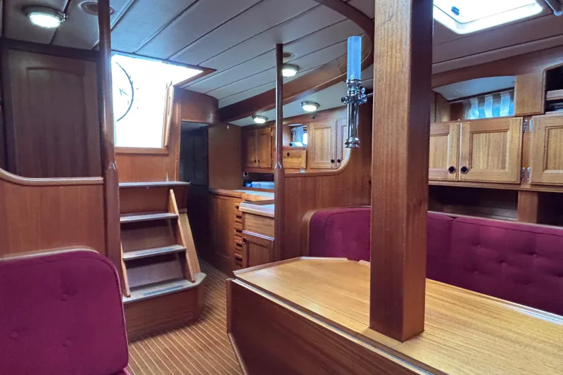 Slide: The Image of Interior of 1992 Najad 390 yacht with wooden finish and red upholstery. - 34