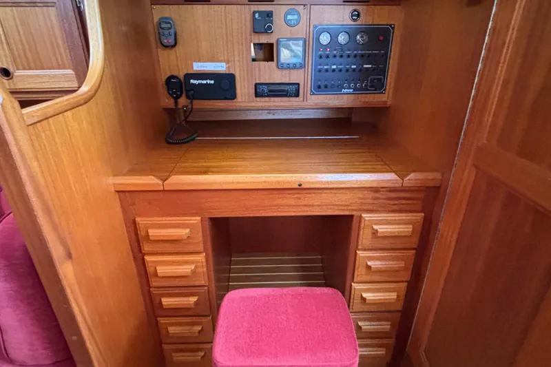 Slide: The Image of Navigation station of a 1992 Najad 390 yacht with wooden cabinetry and control panel. - 36