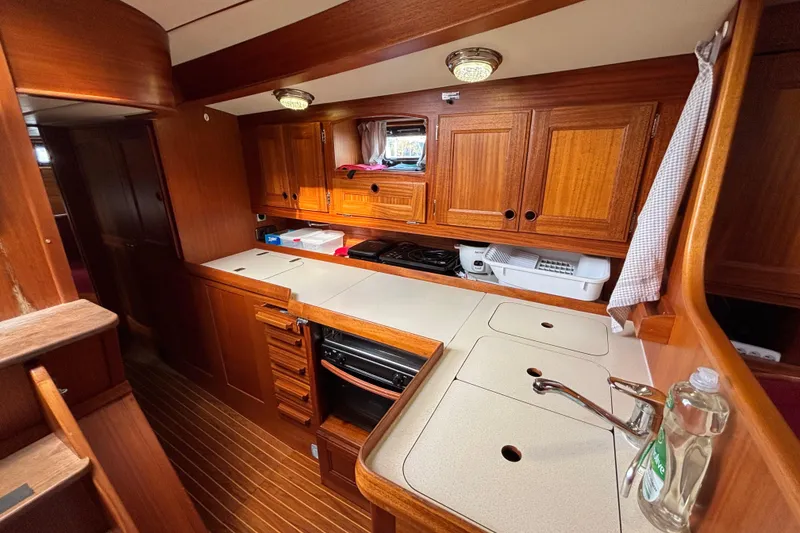 Slide: The Image of Interior of 1992 Najad 390 yacht kitchen with wooden cabinetry and modern appliances. - 38