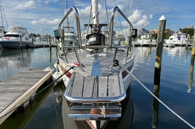 Slide: The Image of 1992 Najad 390 sailboat docked at a marina, clear sky, calm water. - 4