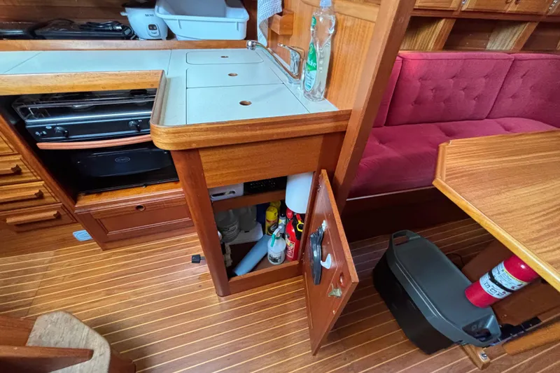 Slide: The Image of Interior of 1992 Najad 390 yacht with wooden cabinetry and red seating. - 40
