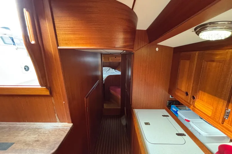 Slide: The Image of Interior of 1992 Najad 390 sailboat with wooden cabinetry and cozy sleeping area. - 41